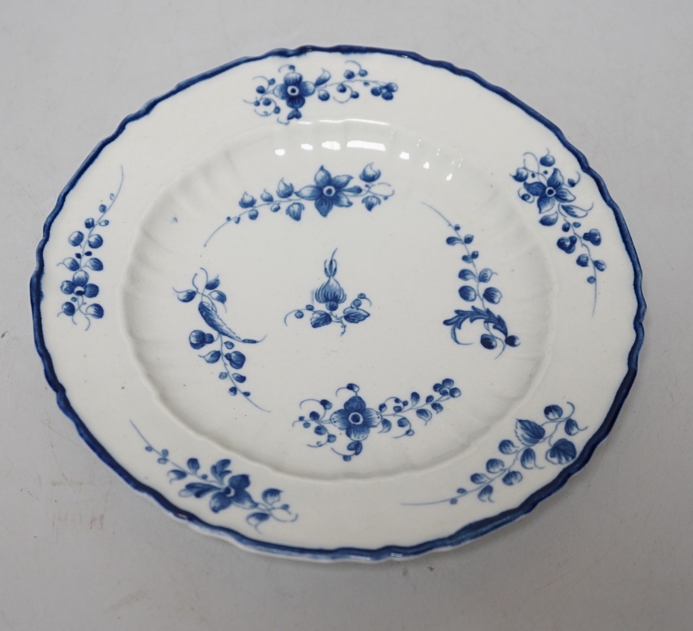 An 18th century Caughley plate painted, with bright, sprigs, impressed mark Salopian, 19.5cms diameter